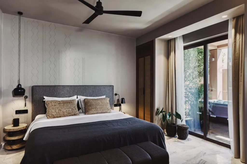 Domes of elounda premium suite with outdoor jacuzzi bedroom